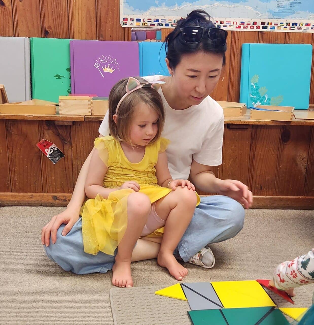 Montessori 3-6 - teacher and child exploring shapes in Napier